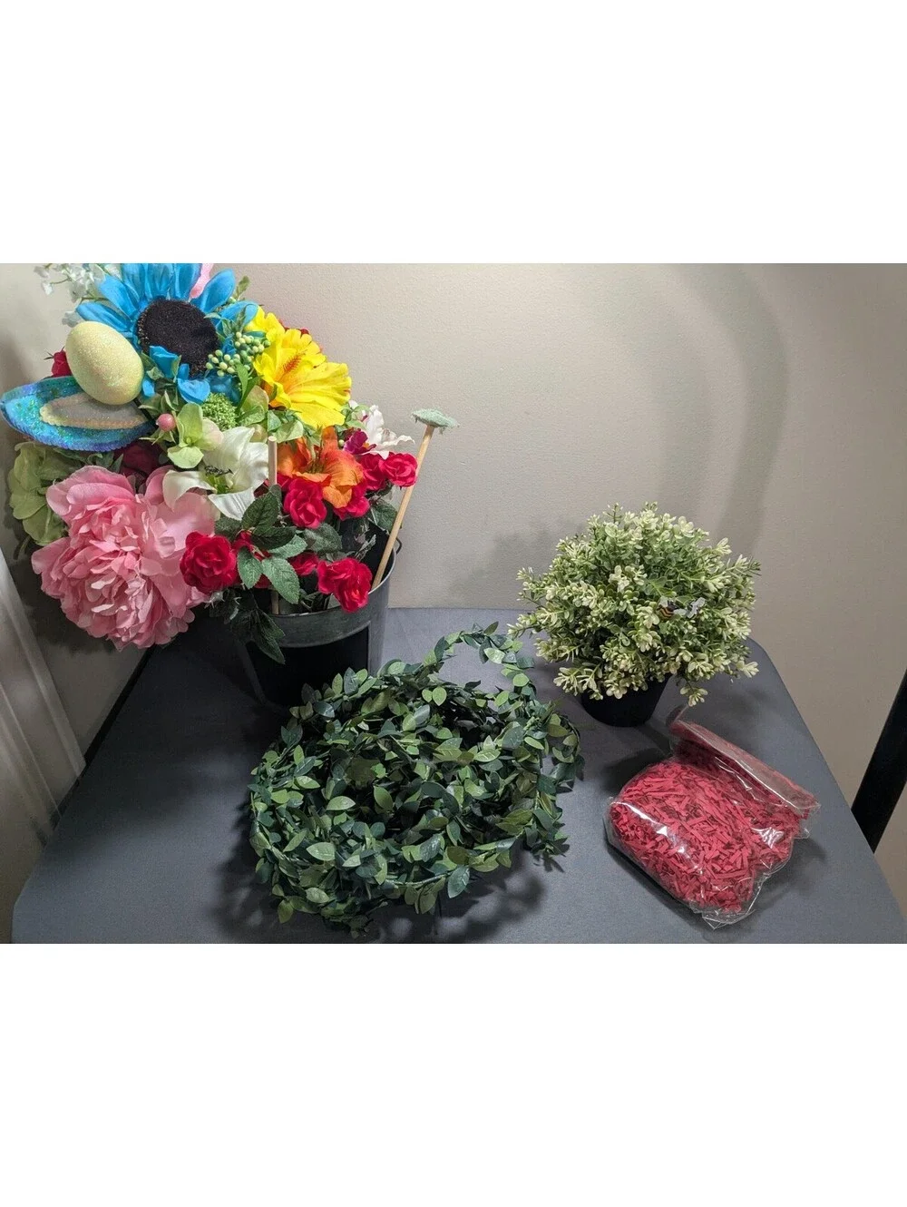 Artificial Flower Arrangement with Decorative Greenery and Shredded Paper Filler